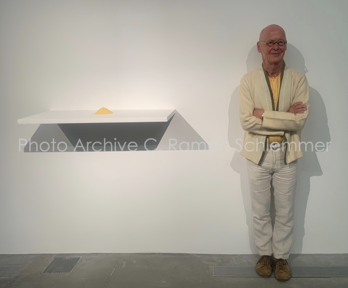 Artist Wolfgang Laib next to his installation at the Galleria Lia Rumma